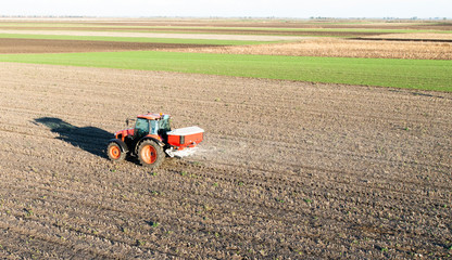 Tractor spreading artificial fertilizers