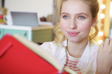 Positive delighted girl being deep in her thoughts