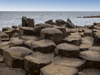 Giant’s Causeway,  Northern Ireland, UK. Unique natural hexagonal and pentagonal geological formations of volcanic basalt rocks, resembling cobblestones