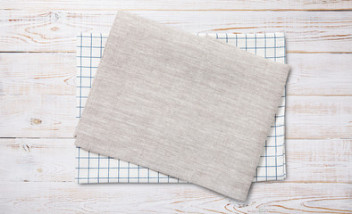 Napkin. Kitchen towel or table cloth on white wooden scene. Mock up for design. Top view.