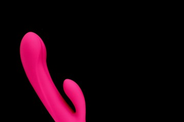 Sex toy for adult, design pink dildo vibrator isolated on black background. Concept of sex,...