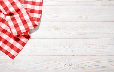 Fototapeta na wymiar Napkin. Kitchen towel or table cloth on white wooden scene. Mock up for design. Top view.
