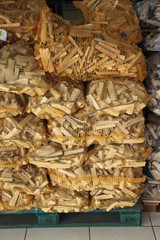Wood logs plastic bags in a supermarket