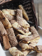 Homemade sandwich puff pastry chocolate cookies in a wicker natural basket of vines. Wooden ancient table.