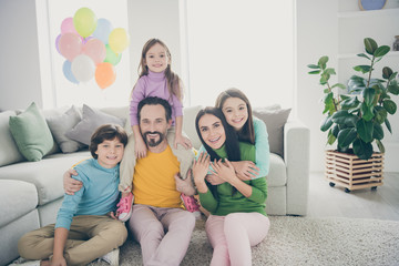 Dream cozy loving family people sit floor carpet mom mommy hug cuddle her small preteen girl dad daddy piggyback younger adopted kid celebrate anniversary day in house living room
