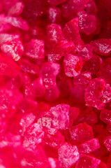 Red crystals minerals bath salts close-up. Macro photo
