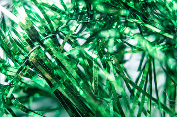 Green festive abstract tinsel close-up. Macro photo