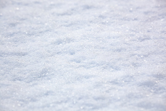 white loose snow texture, sunlight, pieces of ice glisten, winter background