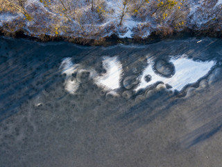 Aerial drone view. Frosty pattern on the lake.