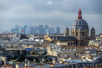Fototapeta na wymiar FEBRUARY 1, 2019 - PARIS, FRANCE: Skyline of Paris rooftops, Saint Augustin church and La Defense district