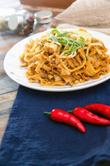 Pad Thai, vegan recipe made with rice noodles, vegetables and peanuts cooked on wok