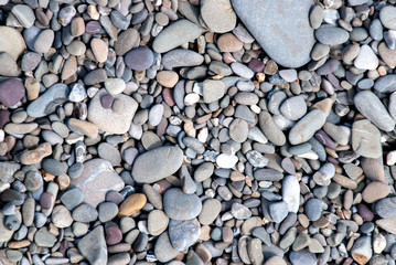 background of pebbles on a gray and brown beach