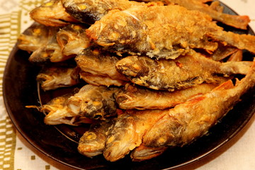 Fried perch on a plate. Cooked fried perch in plate on kitchen table