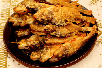 Fried perch on a plate. Cooked fried perch in plate on kitchen table