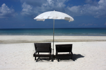 two chairs and umbrella on the beach