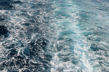 Foam on the sea top view background.  a beautiful rail on the sea or ocean surface behind of speed cruise liner. Wake in the ocean made by large ship.