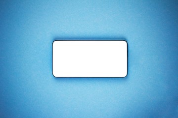 mock-up smartphone with a white screen on a blue background close up top view with a vignette