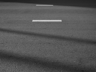 white line on asphalt road with shadow black and white style