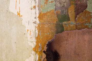 Old wall with peeling wallpaper