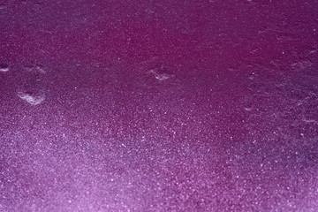 texture of a painted wall. cement plate light purple color background. wall with bumps and small pits.