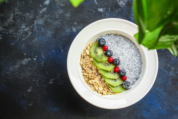healthy food smoothie bowl, oatmeal, chia seeds and berries (breakfast dish or healthy snack) menu concept. background. top view. copy space