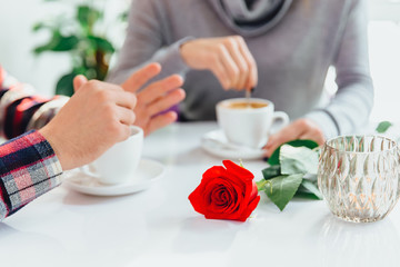 Perfect breakfast of romantic couple concept. Focus on the red rose on the forefront.