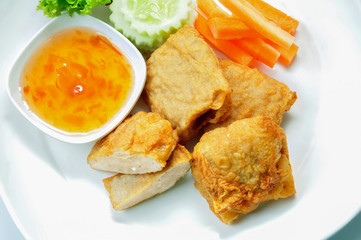 Fried radish cake turnip cake Served with cucumbers, carrots and fresh vegetables and sweet plum Sauce, soft focus. Vegetarian and Vegan food. Vegetarian Festival.