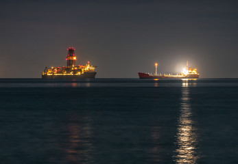 Two industrial ships are at anchor