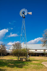old windmill and blue sky on a farm