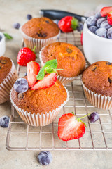 Vanilla muffins or cupcakes with berries