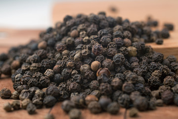 black pepper on wooden background