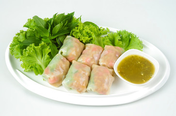 Vietnamese spring roll. Spring rolls with vegetables and rice paper. Fresh Vietnamese spring rolls on a plate with salad. Vietnamese Food.