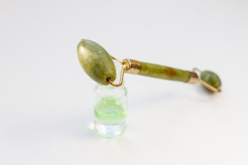perfume bottles and stone massager, cosmetics on white background