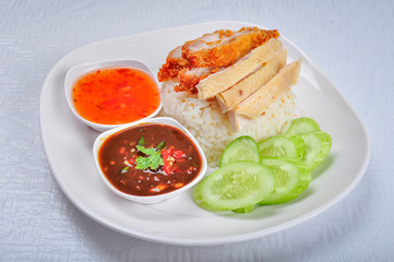 Thai Fried-Chicken and steamed chicken with Rice. Rice with chicken fried Sweet sauce Asian food. Thai food gourmet fried chicken with rice eat with bean chili dipping sauce, fresh cucumber.