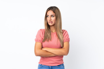 Fototapeta premium Young blonde woman over isolated white background with confuse face expression