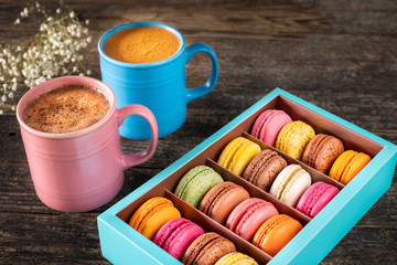 Colorful macarons in the gift box on the table