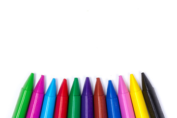 Colored wax pencils. A bunch on white background close-up