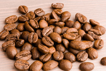 coffee beans. the pile on wooden table. close up