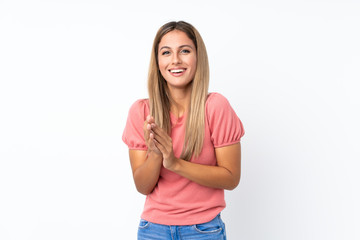Fototapeta premium Young blonde woman over isolated white background applauding after presentation in a conference