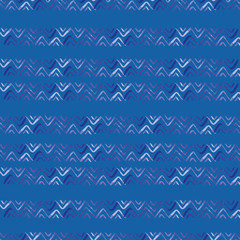 Vector seamless pattern ethnic indigo watercolor with white and blue chevrons and blue background.