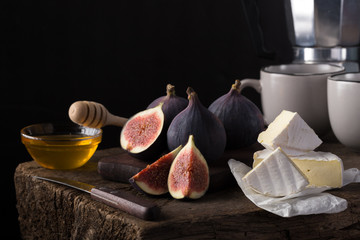 Fresh ripe figs. Breakfast with figs, cheese, honey and nuts. A few figs on an old wooden...