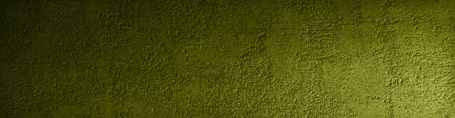 Yellow green grunge background. Rough concrete wall texture in reflection of light closeup. Dirty yellow banner with copy space for your design.
