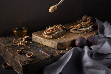 Figs. Sandwiches with figs, cheese, arugula, honey and nuts. toast with creamy yogurt and feta cheese spread, fresh figs with honey. Bruschetta with cheese and figs. Homemade. Everyday autumn kitchen.