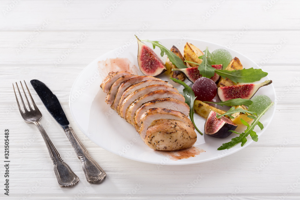 Wall mural baked chicken with fig and arugula salad. chicken breast, fig, arugula. dinner. fried chicken breast