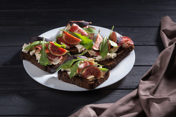 Figs. Sandwiches with figs, cheese, arugula, honey and nuts. toast with creamy yogurt and feta cheese spread, fresh figs with honey. Bruschetta with cheese and figs. Homemade. Everyday autumn kitchen.