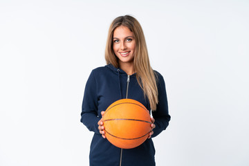 Young woman playing basketball over isolated white background