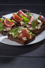 Figs. Sandwiches with figs, cheese, arugula, honey and nuts. toast with creamy yogurt and feta cheese spread, fresh figs with honey. Bruschetta with cheese and figs. Homemade. Everyday autumn kitchen.