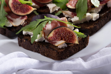Figs. Sandwiches with figs, cheese, arugula, honey and nuts. toast with creamy yogurt and feta cheese spread, fresh figs with honey. Bruschetta with cheese and figs. Homemade. Everyday autumn kitchen.