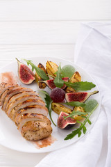 Baked chicken with fig and arugula salad. Chicken breast, fig, arugula. Dinner. Fried chicken breast with vegetables and figs. Dish with figs. fried chicken with figs and onions. Free space for text. 