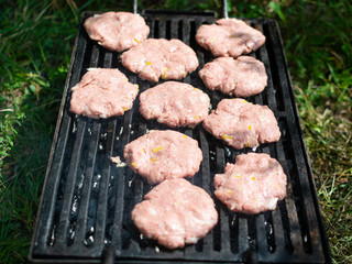 Summer barbecue. Fresh burgers on grill